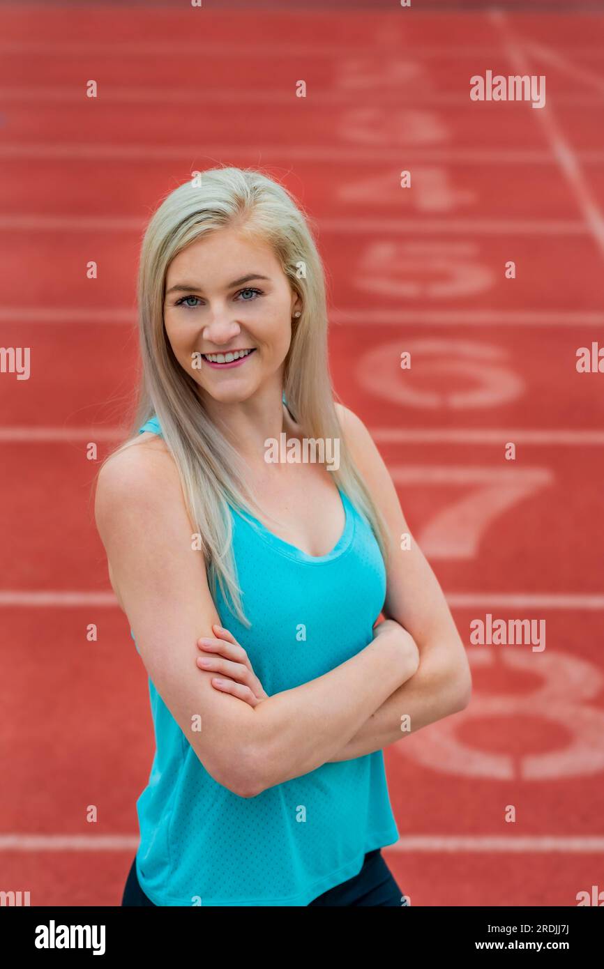 A beautiful young college athlete prepares herself for a track meet at a local university Stock Photo
