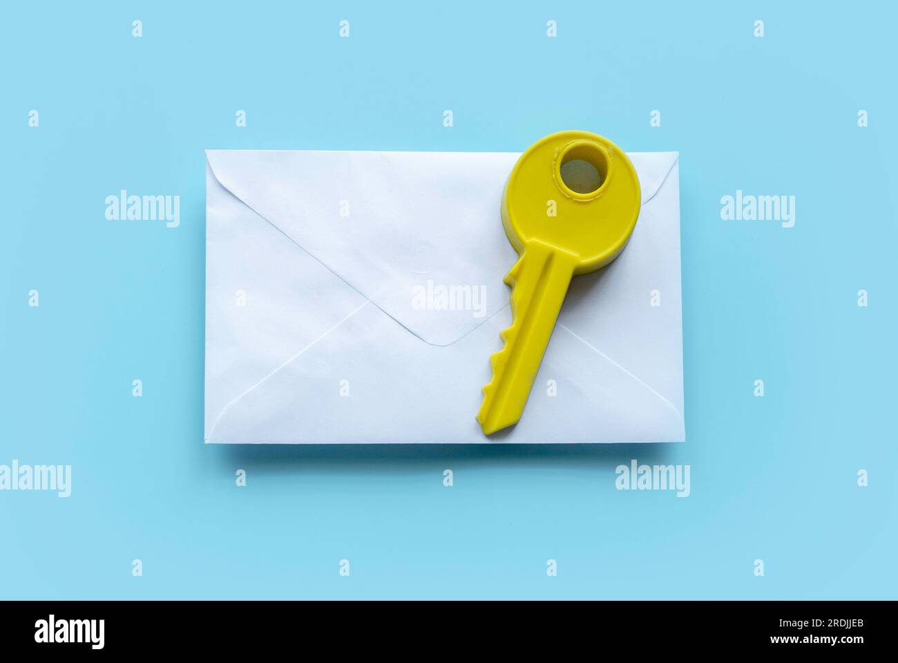 Concept of email security, secure communication, secret and confidential. Key above white envolope over a blue background. Stock Photo