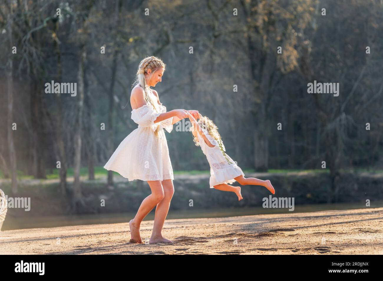 A beautiful young mother and her daughter enjoy the spring weather Stock Photo