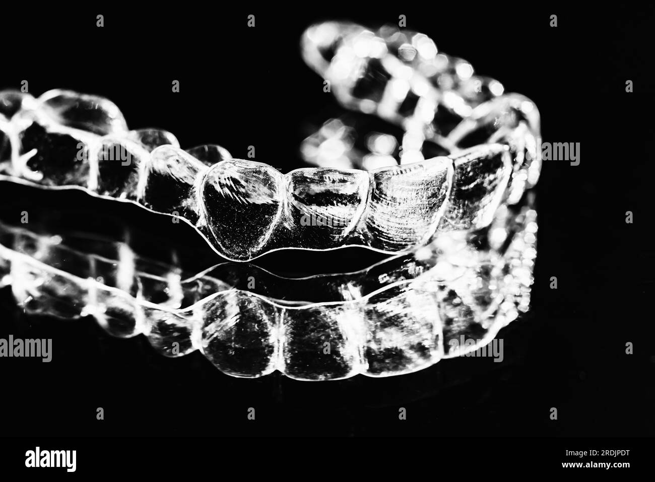 Invisible aligner teeth retainers on a black background Stock Photo Alamy