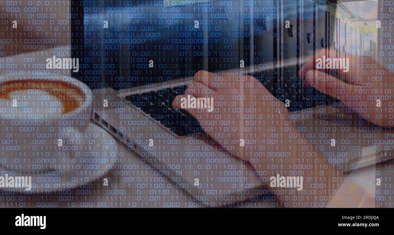 Composite of binary coding data processing over caucasian woman using laptop Stock Photo