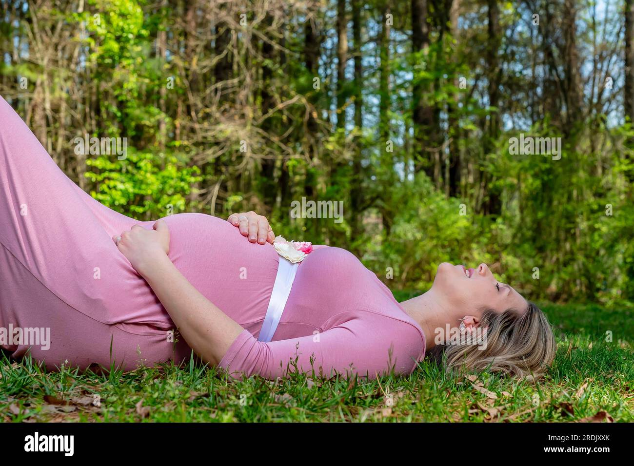 A beautiful expectant mother poses in an outdoor environment Stock