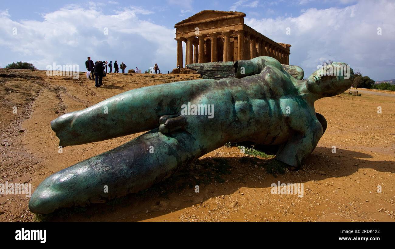 Super wide angle shot, bronze statue of fallen Icarus, Concordia Temple, Valley of the Temples, valle dei templi, Agrigento, Sicily, Italy Stock Photo