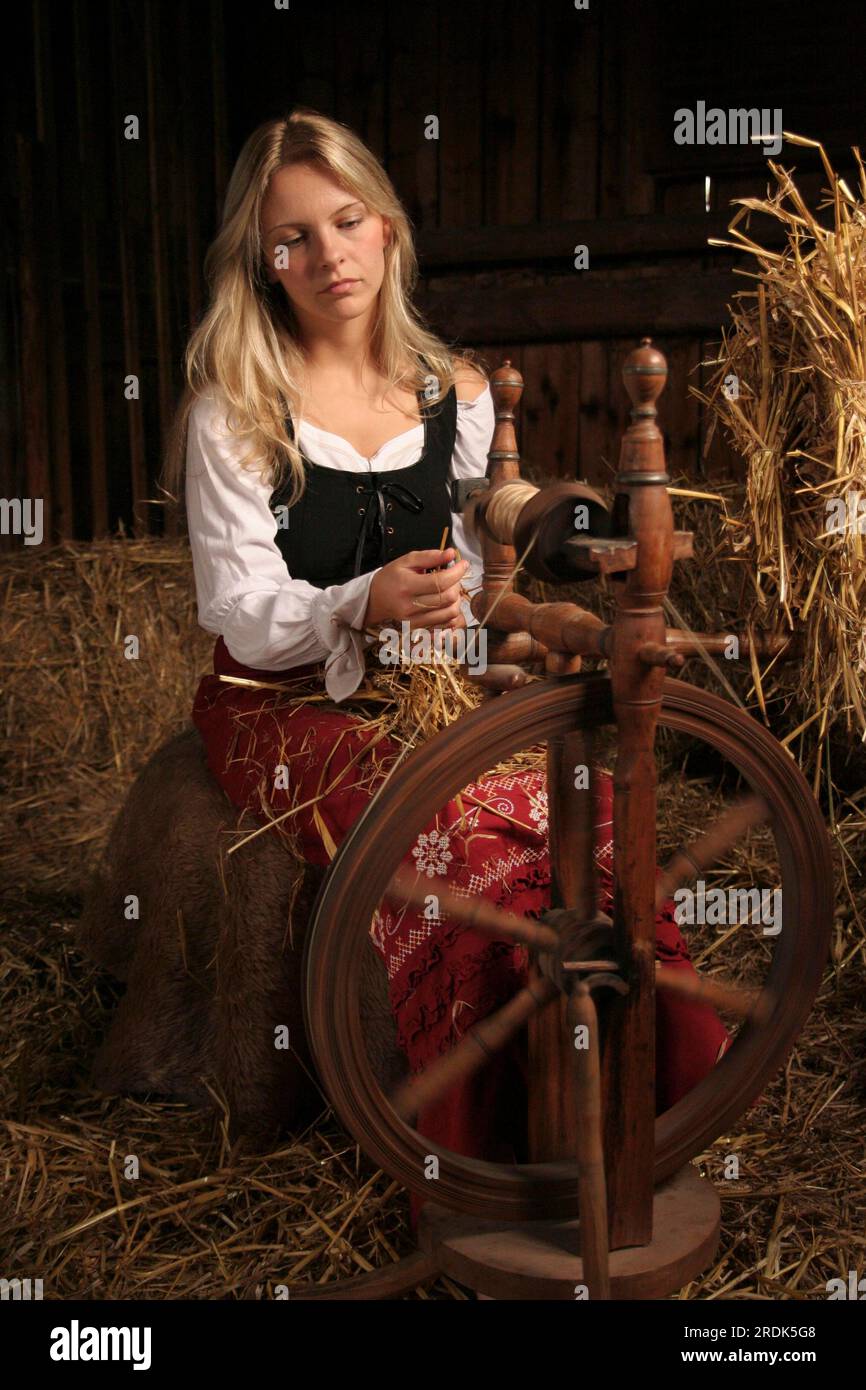 Spinner, miller's daughter, spinning straw into gold Stock Photo Alamy