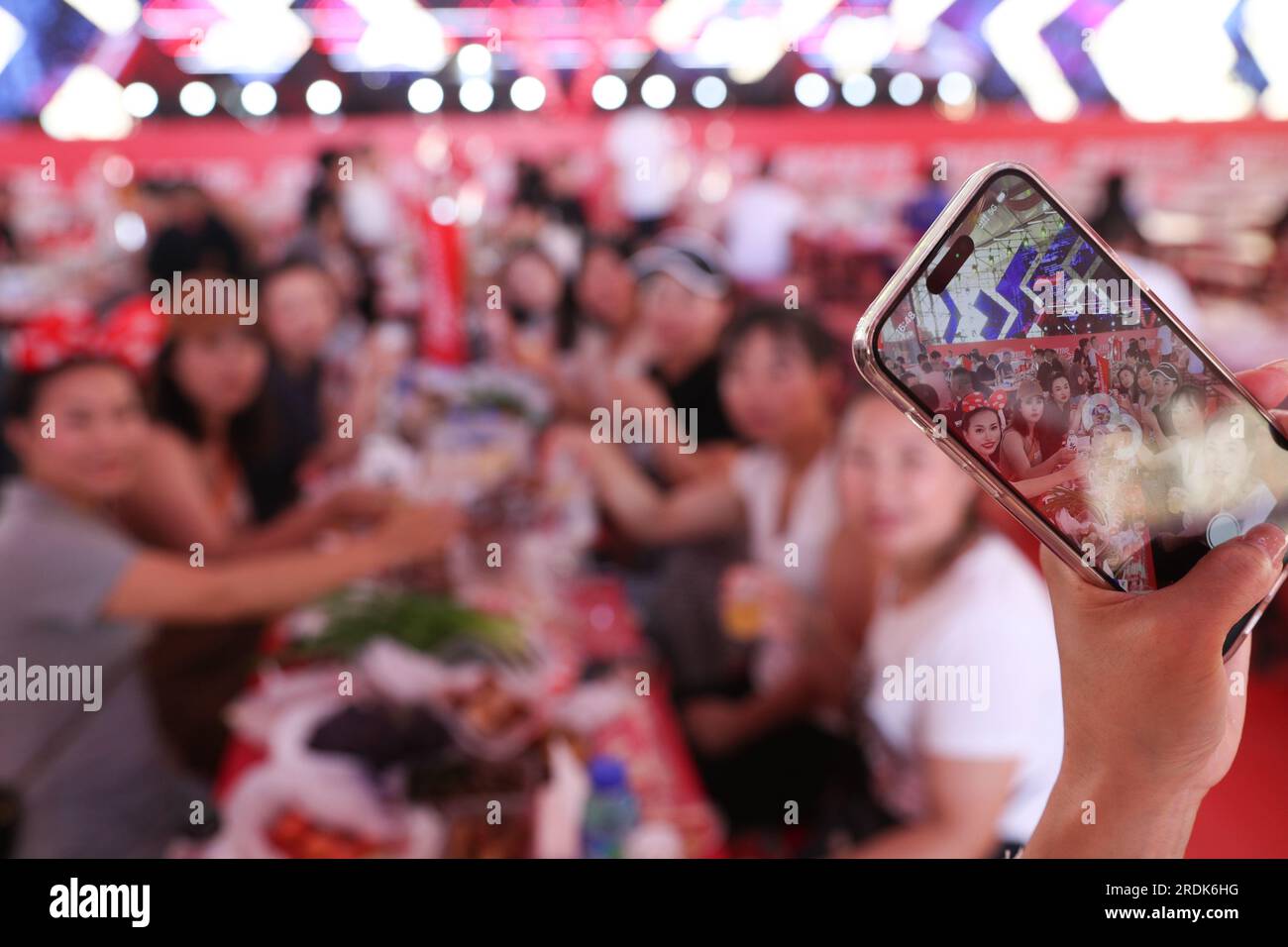 Beijing, China's Heilongjiang Province. 20th July, 2023. Visitors pose for photos at the 21th China Harbin International Beer Festival in Harbin, capital of northeast China's Heilongjiang Province, July 20, 2023. Credit: Zhang Tao/Xinhua/Alamy Live News Stock Photo