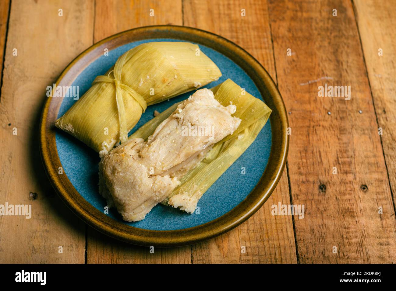 Tamales de elote on a wooden table. Typical Mexican food Stock Photo