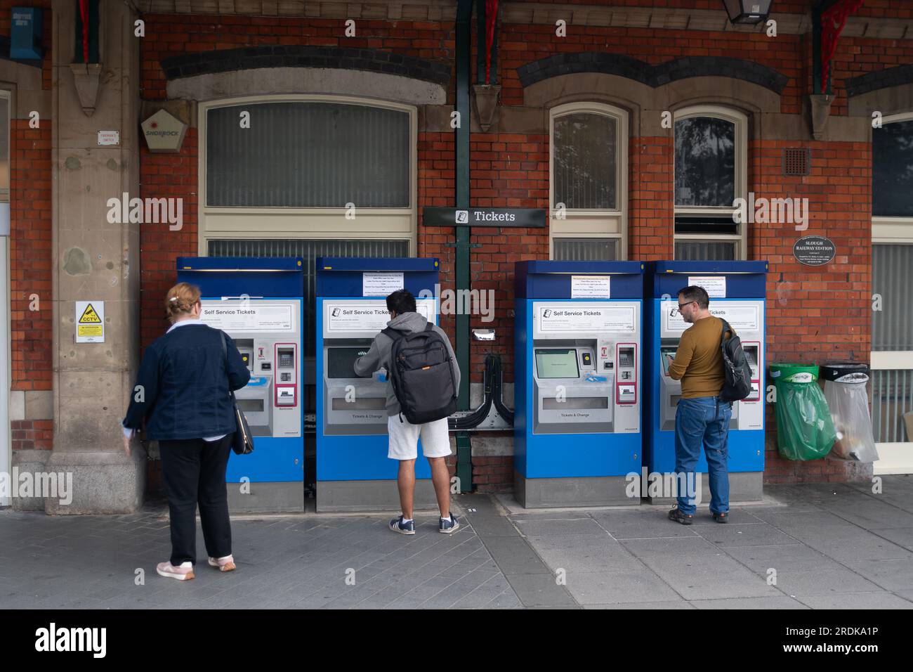Slough, UK. 22nd July, 2023. Passengers using self service ticket machines at Slough Station. Although some GWR trains were running today, Slough Railway Station in Berkshire was quiet this morning due to GWR Industrial Action. RMT Strikes are taking place across parts of the rail network in England today in an ongoing dispute about pay and the closure of railyway station ticket offices. The Rail Industry Body, The Rail Delivery Group have announced that plans to close the majority of all railway station ticket offices in England have been confirmed.  This is a huge blow to rail workers, many Stock Photo