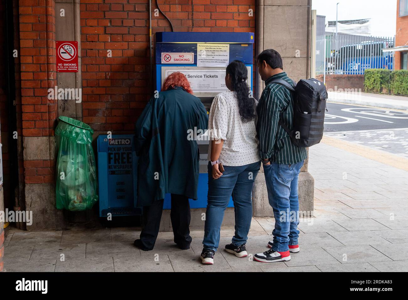 Slough, UK. 22nd July, 2023. Passengers using self service ticket machines at Slough Station. Although some GWR trains were running today, Slough Railway Station in Berkshire was quiet this morning due to GWR Industrial Action. RMT Strikes are taking place across parts of the rail network in England today in an ongoing dispute about pay and the closure of railyway station ticket offices. The Rail Industry Body, The Rail Delivery Group have announced that plans to close the majority of all railway station ticket offices in England have been confirmed.  This is a huge blow to rail workers, many Stock Photo