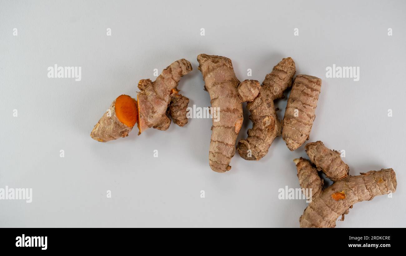 Turmeric (Curcuma longa Linn) rhizome (root) sliced isolated on white background. Stock Photo