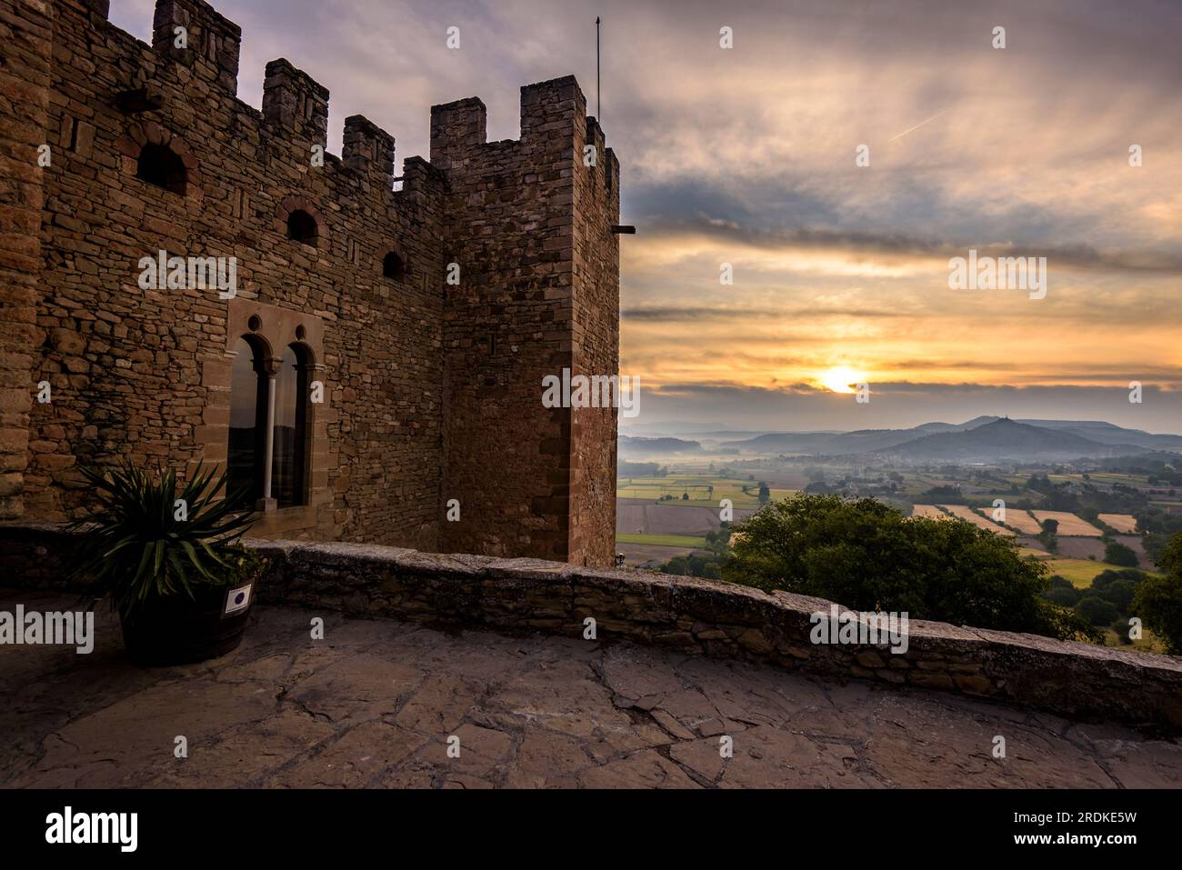 Montsonís Castle in the morning in a backlight with the Sun and high clouds (La Noguera, Lleida, Catalonia, Spain) ESP: Castillo de Montsonís Stock Photo
