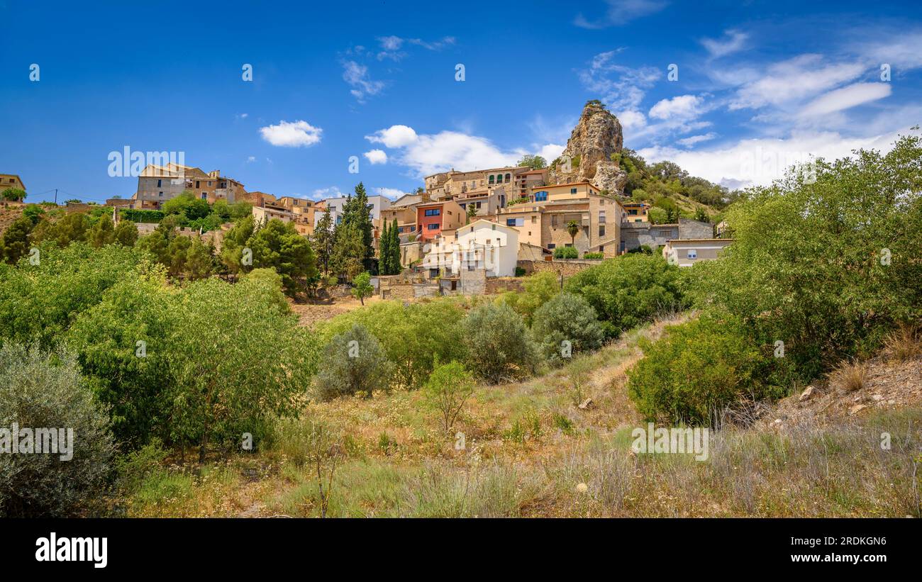 Village of Foradada in a spring noon with the characteristic rock that culminates the village (La Noguera, Lleida, Catalonia, Spain) Stock Photo