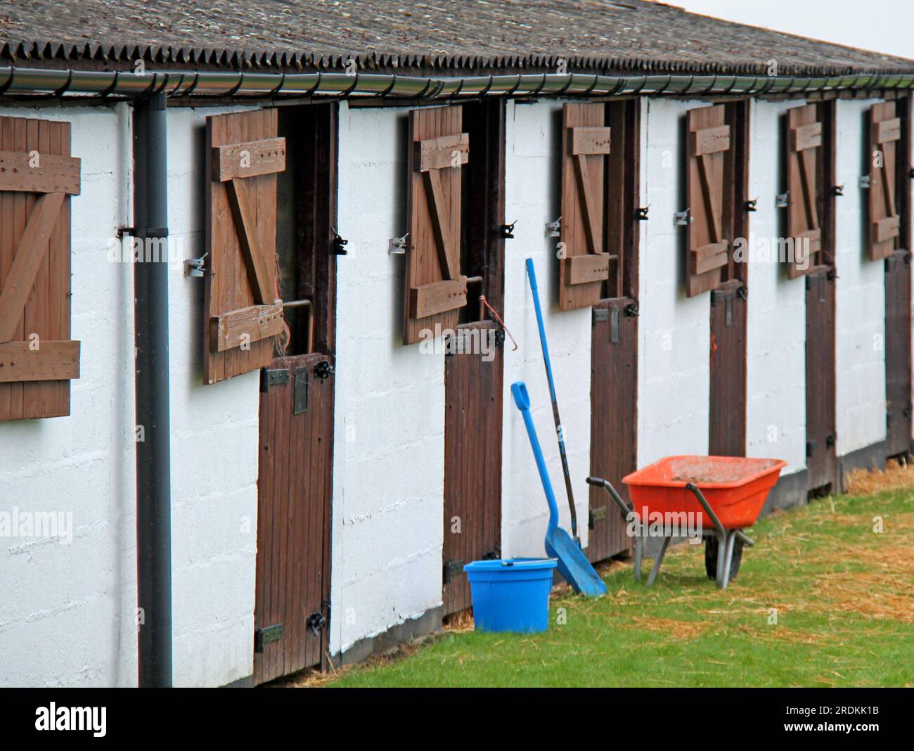 A Wheelbarrow and Tools for Mucking Out Horse Stables Stock Photo Alamy