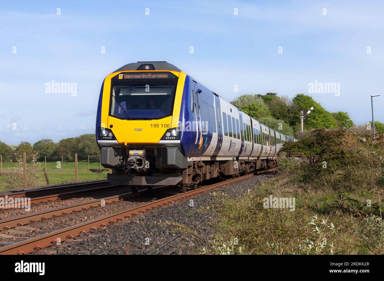 Northern rail CAF class 195 Civity train passing, Arnside, Cumbria on the Cumbrian coast railway line Stock Photo