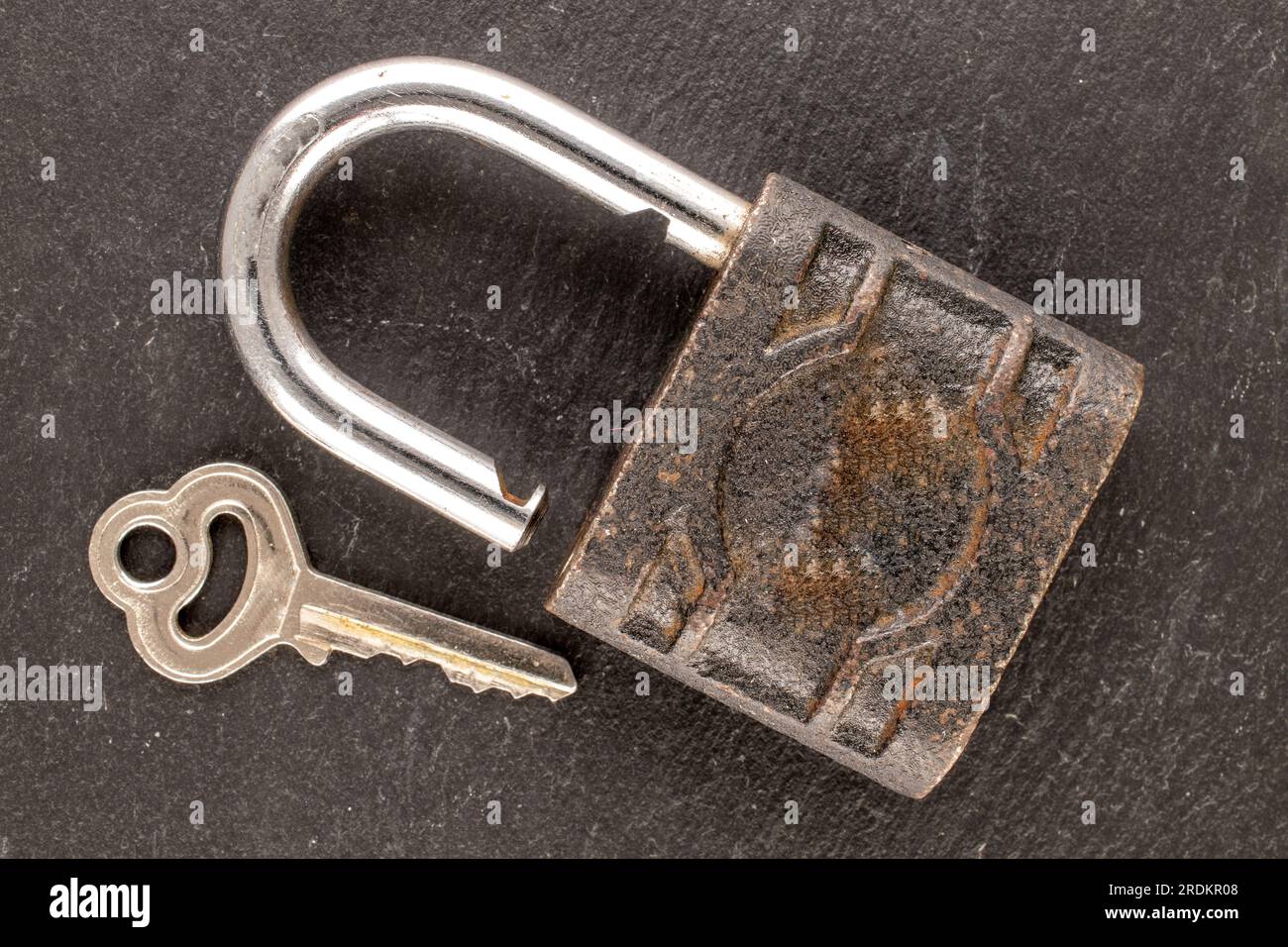 One door lock and key on slate stone, close-up, top view. Stock Photo