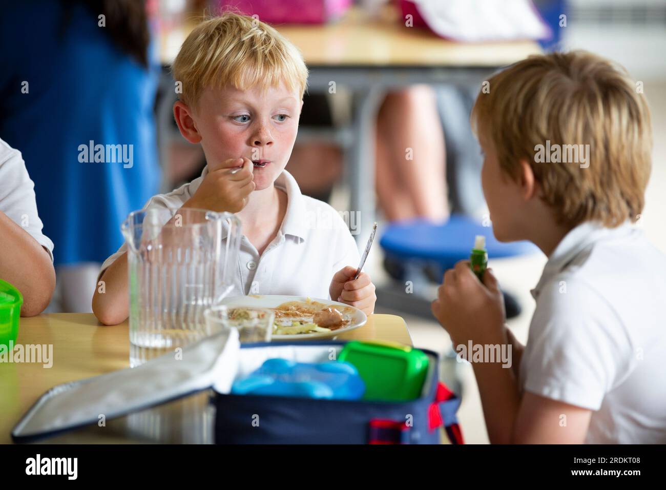 eating school lunch at a primary school in Worcestershire, UK Stock Photo