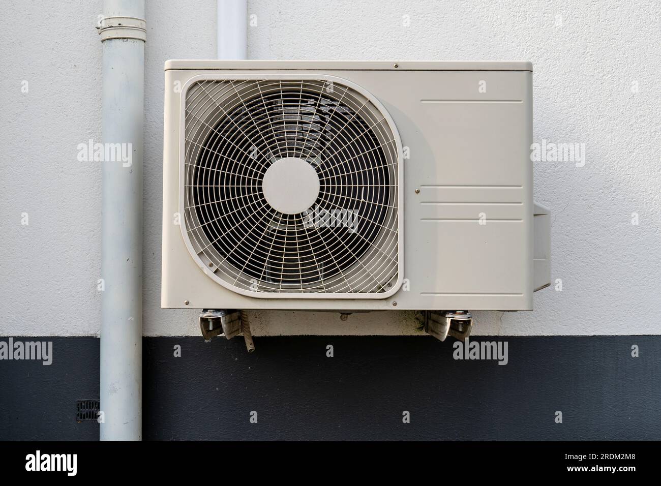 air conditioner condenser unit at exterior wall Stock Photo