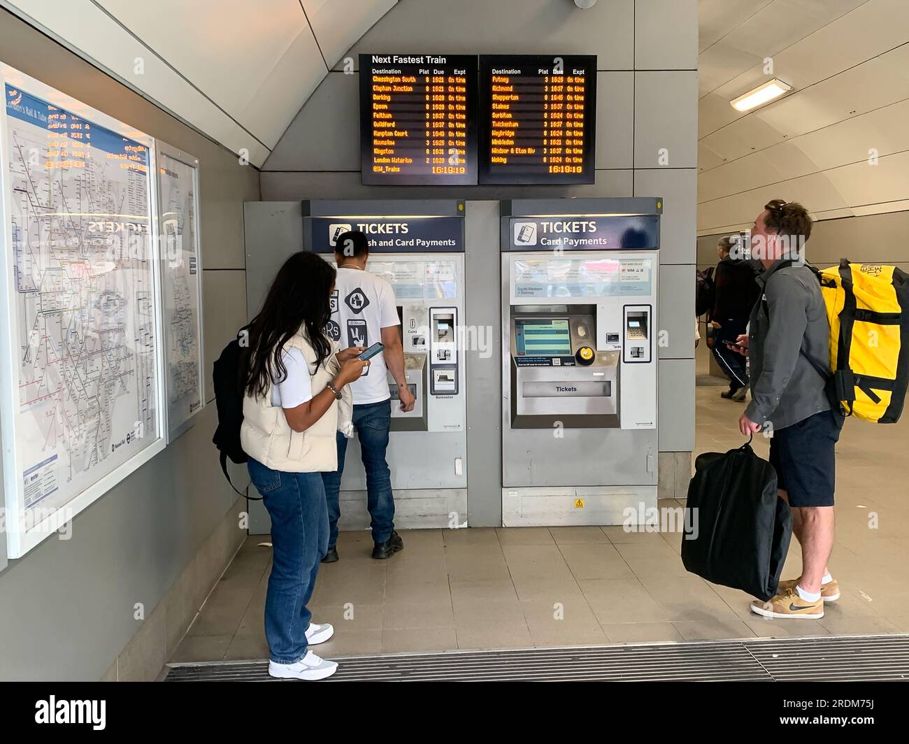 Vauxhall, London, UK. 18th July, 2023. Passengers using Self Service ticket machines at Vauxhall Railway Station. RMT Strikes are taking place across parts of the rail network in England this Saturday in an ongoing dispute about pay and the closure of railyway station ticket offices. The Rail Industry Body, The Rail Delivery Group have announced that plans to close the majority of all railway station ticket offices in England have been confirmed.  This is a huge blow to rail workers, many of whom, fear they will lose their jobs. It is also being criticised by those with mobility issues, disabl Stock Photo