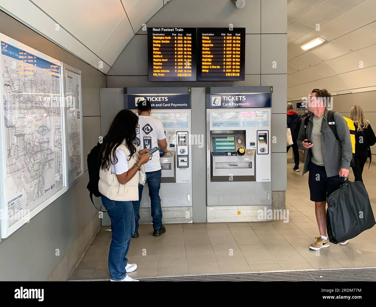 Vauxhall, London, UK. 18th July, 2023. Passengers using Self Service ticket machines at Vauxhall Railway Station. RMT Strikes are taking place across parts of the rail network in England this Saturday in an ongoing dispute about pay and the closure of railyway station ticket offices. The Rail Industry Body, The Rail Delivery Group have announced that plans to close the majority of all railway station ticket offices in England have been confirmed.  This is a huge blow to rail workers, many of whom, fear they will lose their jobs. It is also being criticised by those with mobility issues, disabl Stock Photo