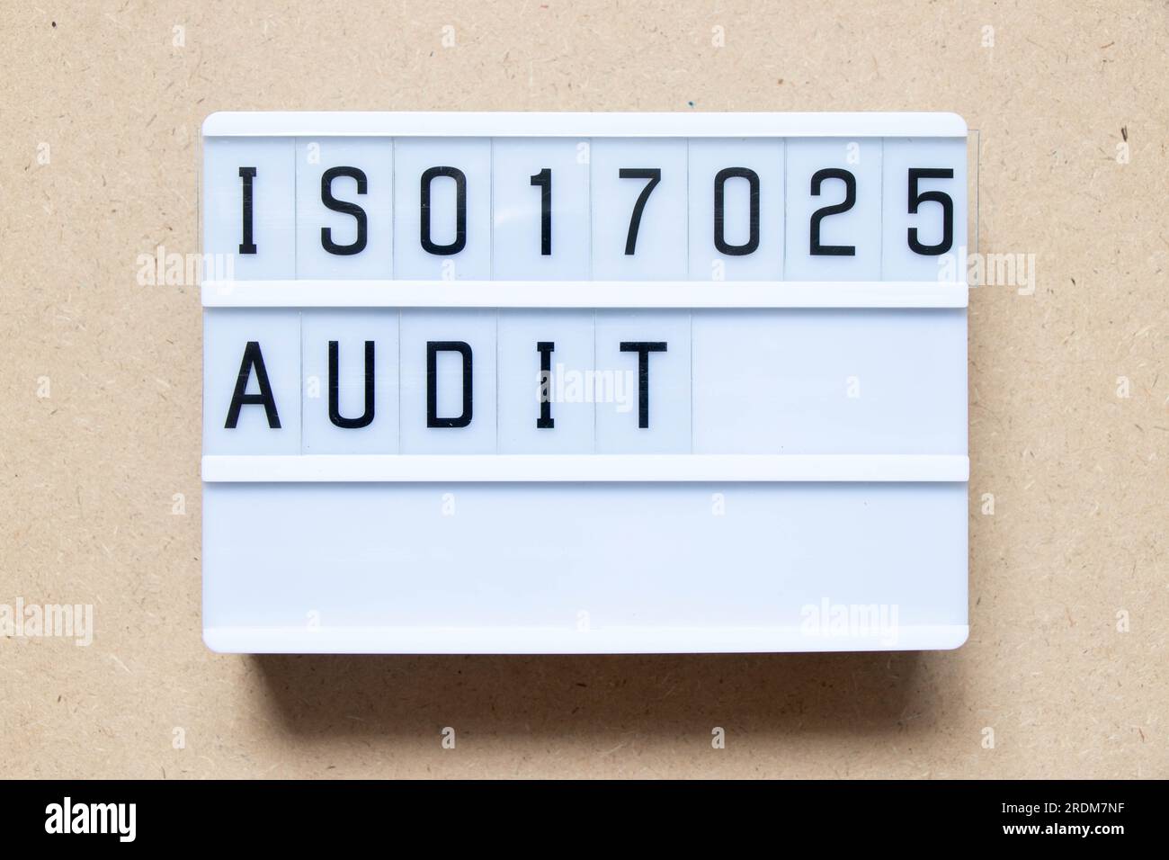 Lightbox with word ISO 17025 audit on wood background Stock Photo