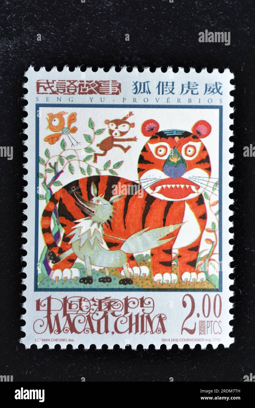 MACAU - CIRCA 2001: A stamps printed in Macao shows Seng Yu Idioms - A Fox Borrowing the Tiger's Ferocity,circa 2001 Stock Photo