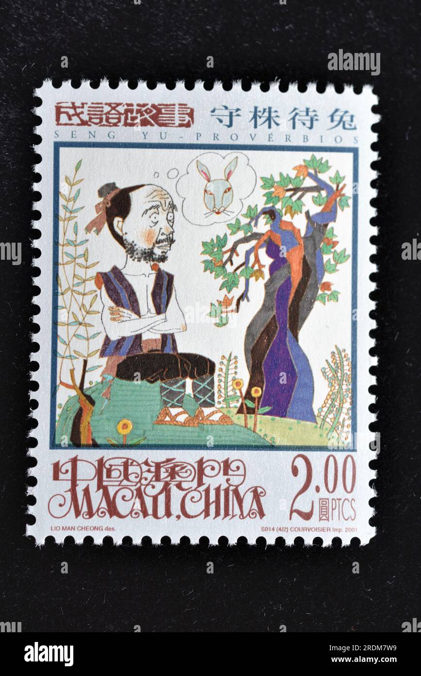 MACAU - CIRCA 2001: A stamps printed in Macao shows Seng Yu Idioms - Waiting by the Stump for Hares,circa 2001 Stock Photo