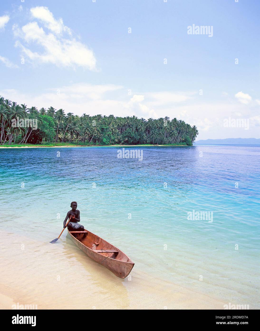 Solomon Islands. Gizo. Coast view. Sagheraghi Beach. Local boy in canoe. Stock Photo
