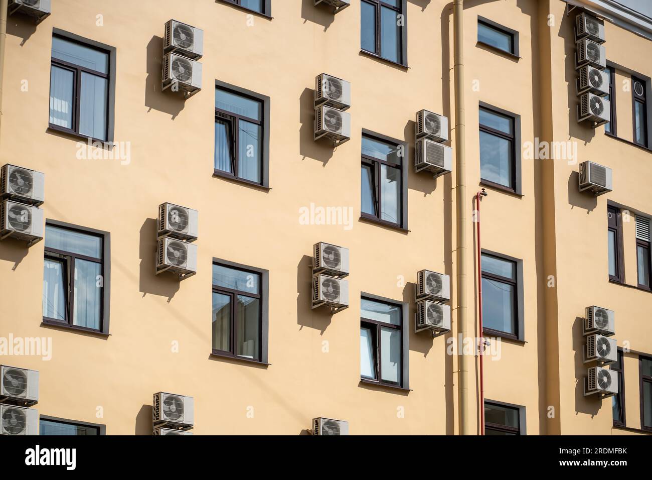 Facade of building with many air conditioners on windows in southern ...