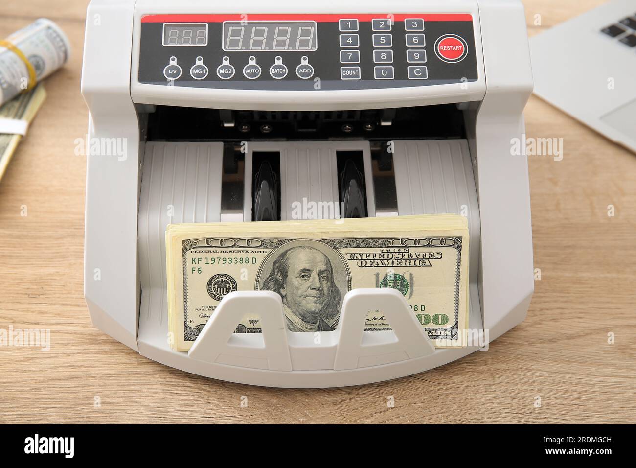 Cash counting machine with dollar banknotes on table in office, closeup ...
