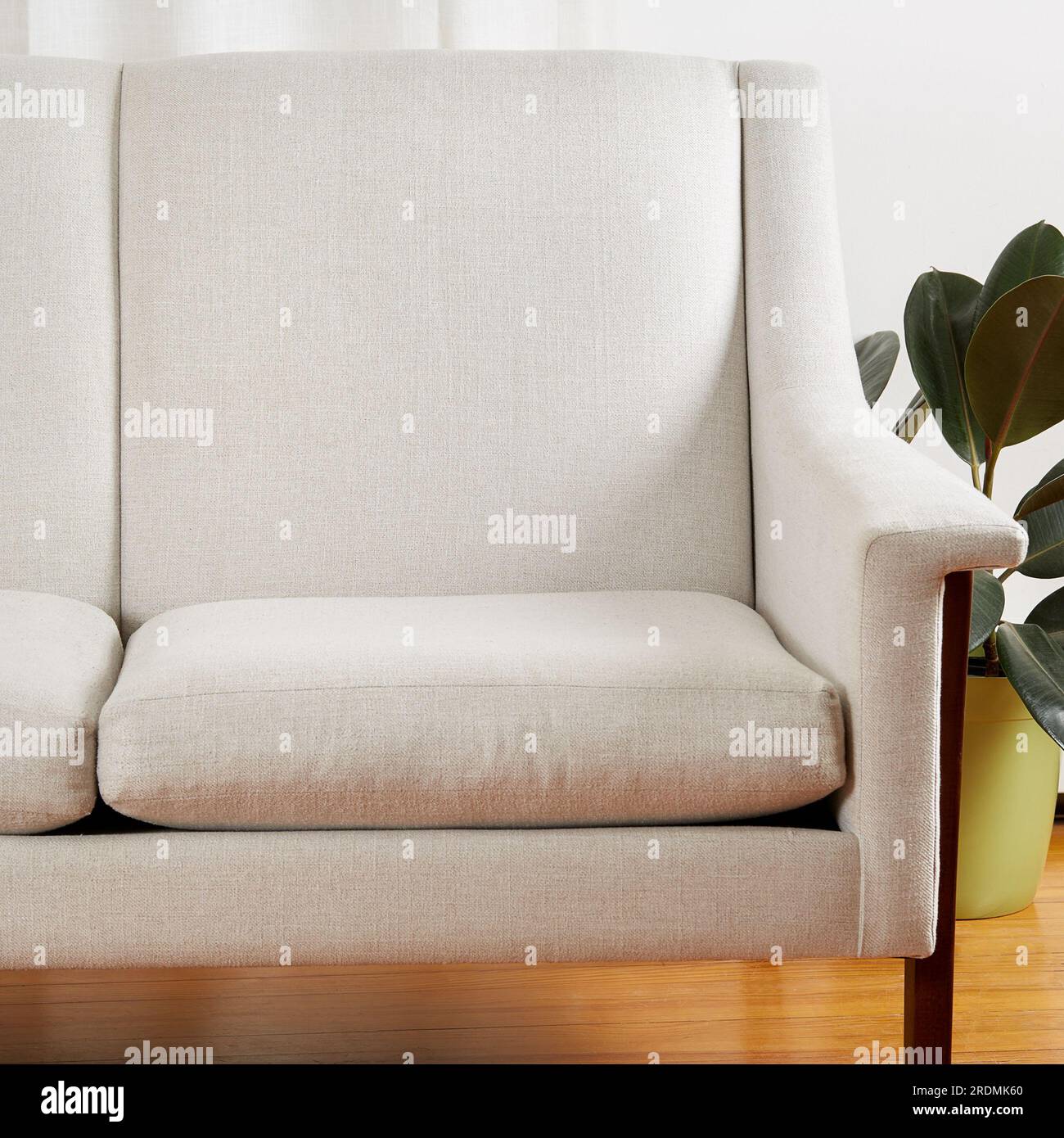 Vintage white sofa. Stylish midcentury modern couch with sculptural