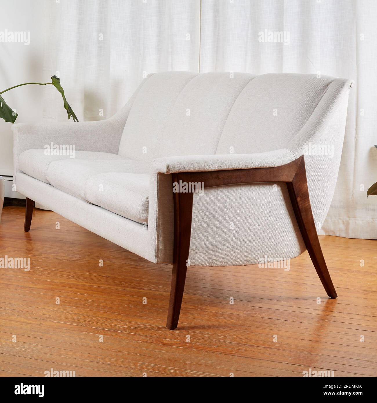 Vintage white sofa. Stylish midcentury modern couch with sculptural