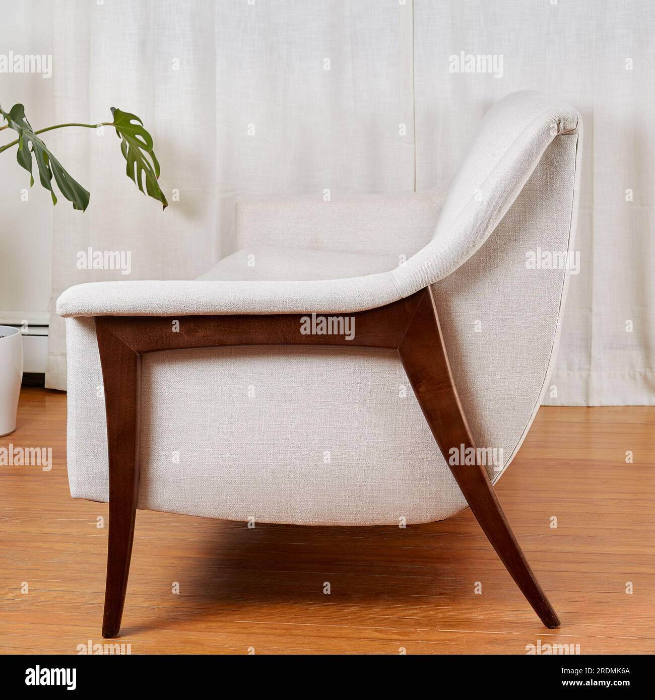 Vintage white sofa. Stylish midcentury modern couch with sculptural