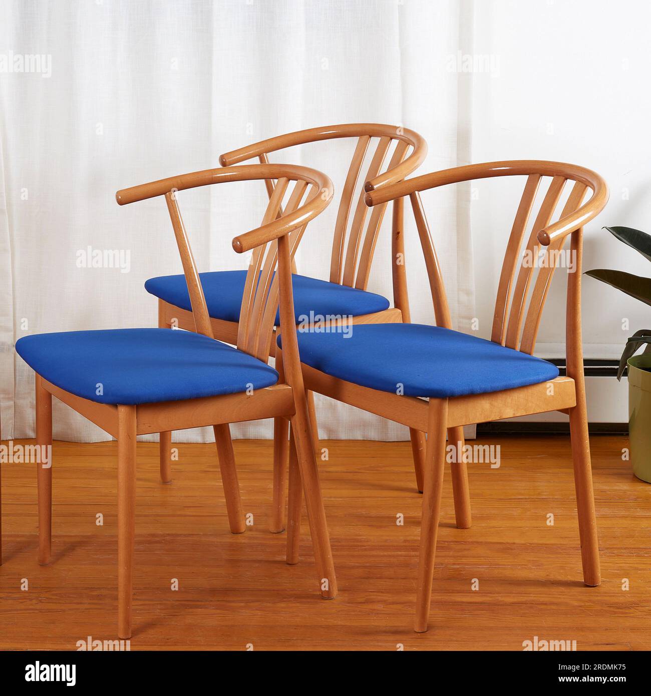 Three Midcentury modern minimalist wooden chairs with blue seats