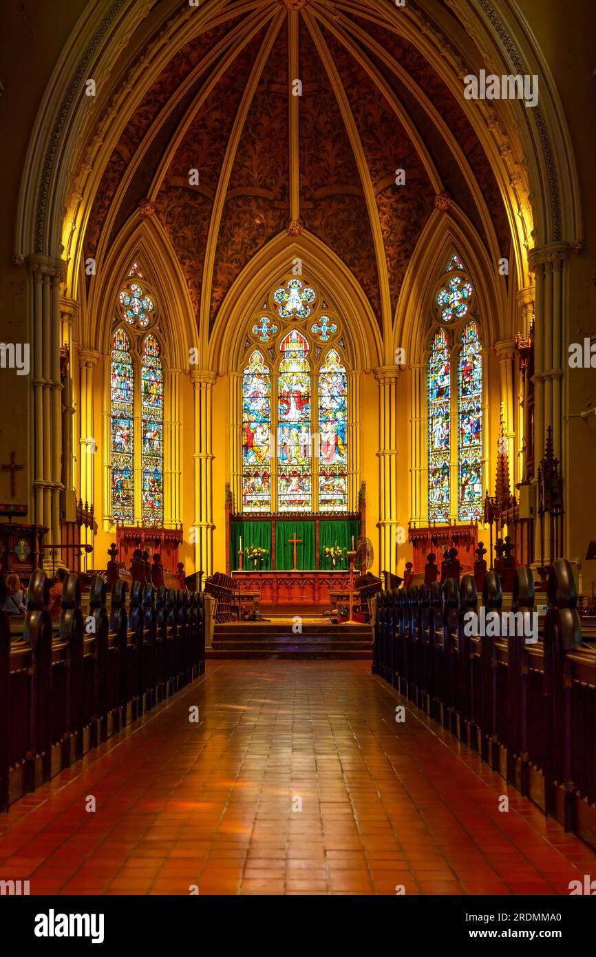 Toronto, Canada - July 19, 2023: The Cathedral Church of St. James. Symmetry of leading lines to the stained-glass windows in the altar. Indoors archi Stock Photo