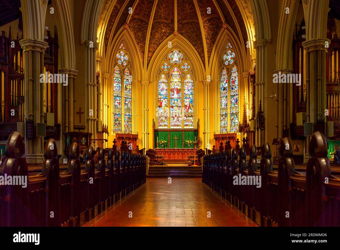 Toronto, Canada - July 19, 2023: The Cathedral Church of St. James. Symmetry of leading lines to the stained-glass windows in the altar. Indoors archi Stock Photo