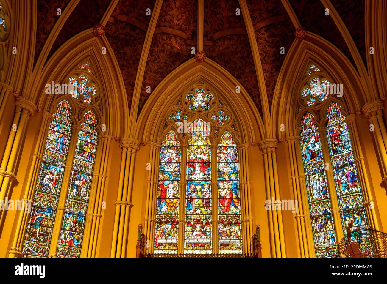 Toronto, Canada - July 19, 2023: The Cathedral Church of St. James. Religious symbols in a multi-colored stained glass window in the altar. Stock Photo