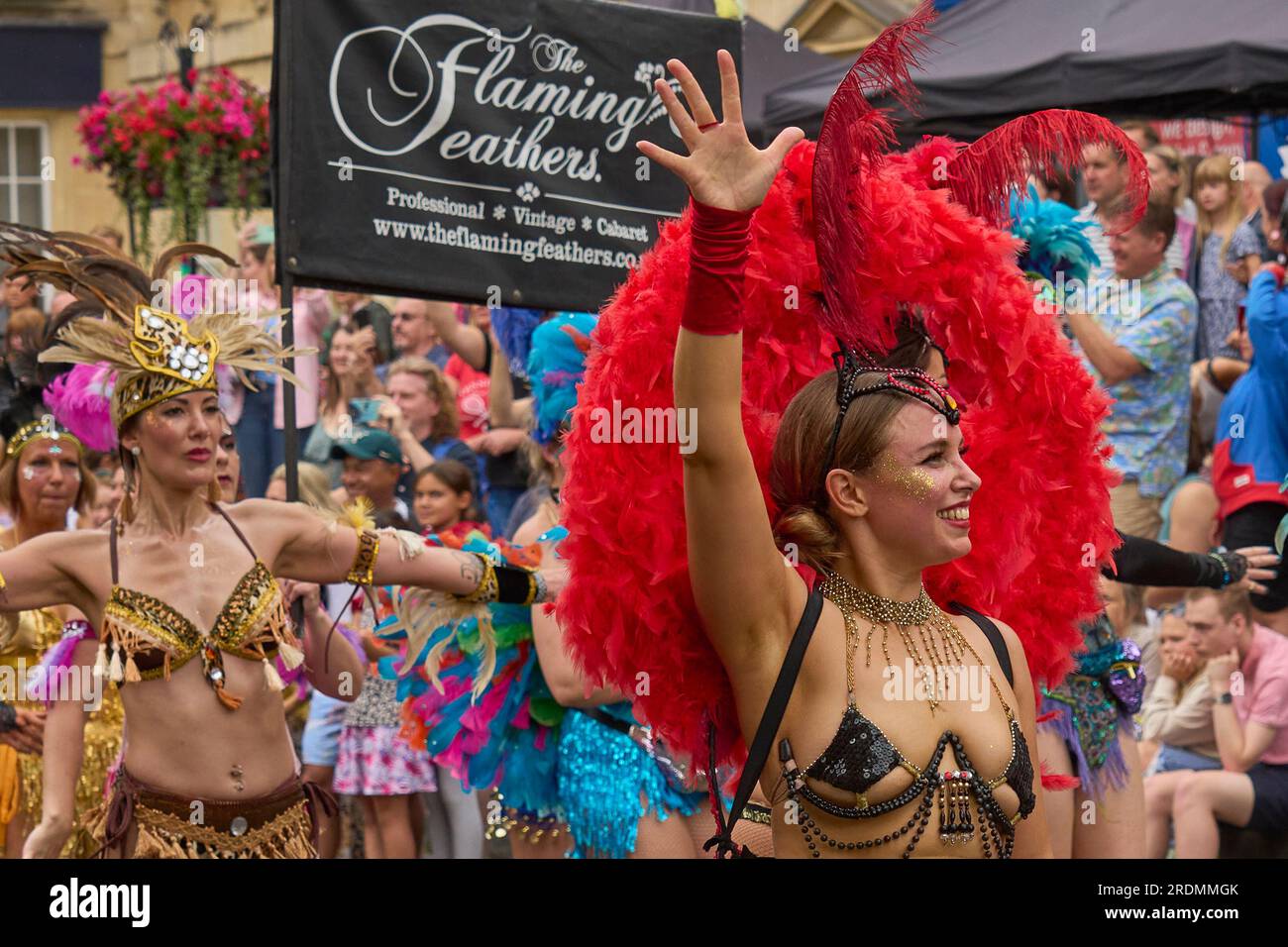 Dancers and musicians dressed in ornate costumes parade through