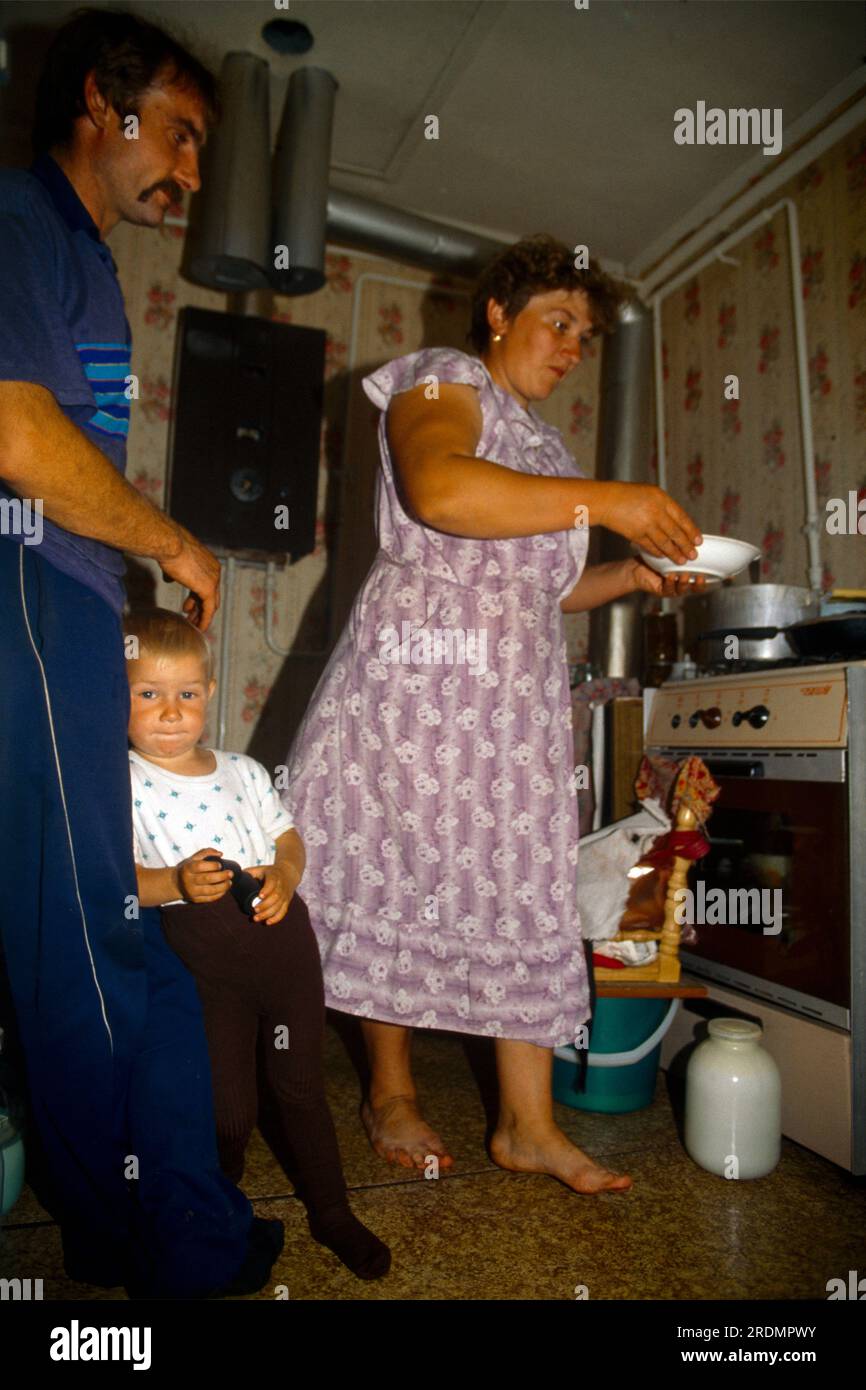 Protasova Orlovskaya Russia Woman Preparing Meal Husband And Son Waiting Stock Photo