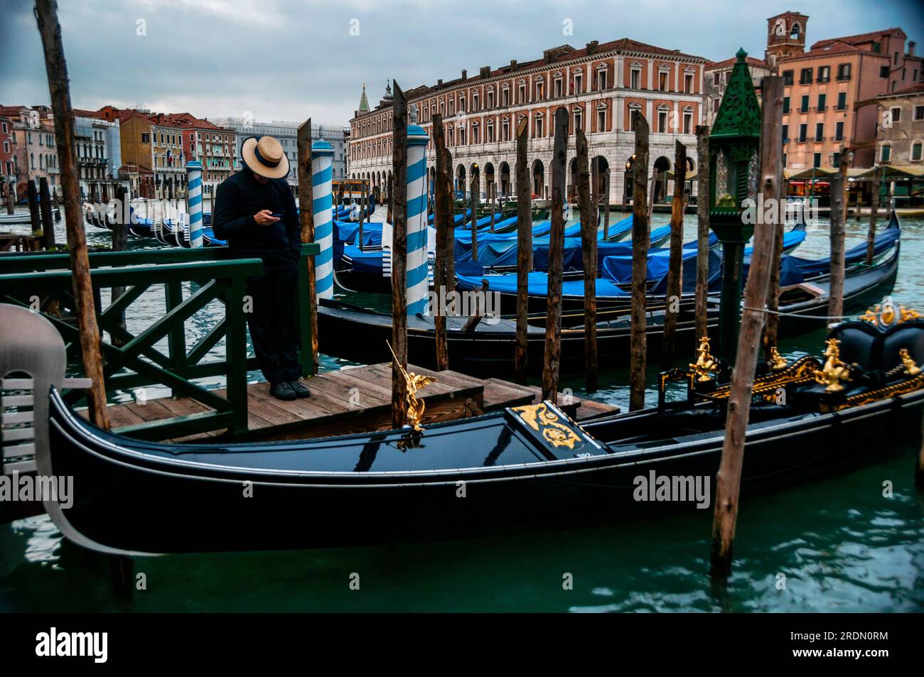 Gondolier in the quietude of December in Venice, Italy Stock Photo