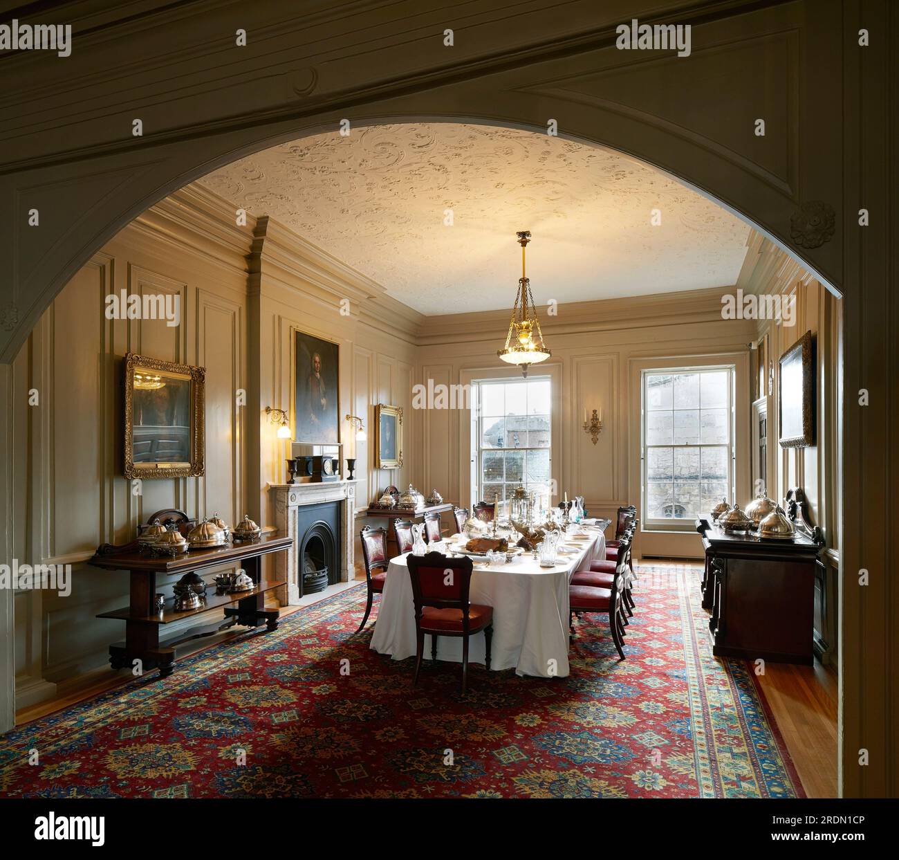 Dining room table set with silver, glass and dinnerware. York Mansion House, York, United Kingdom. Architect: De Matos Ryan, 2018. Stock Photo