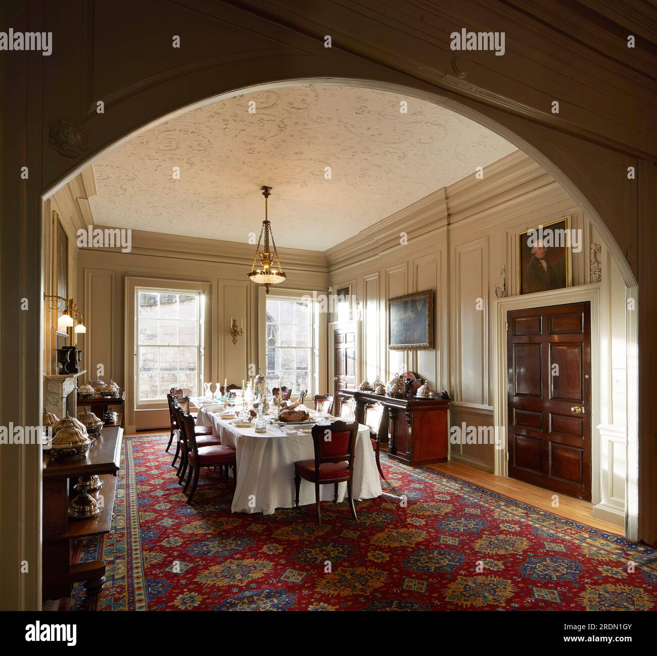 Dining room table set with silver, glass and dinnerware. York Mansion House, York, United Kingdom. Architect: De Matos Ryan, 2018. Stock Photo