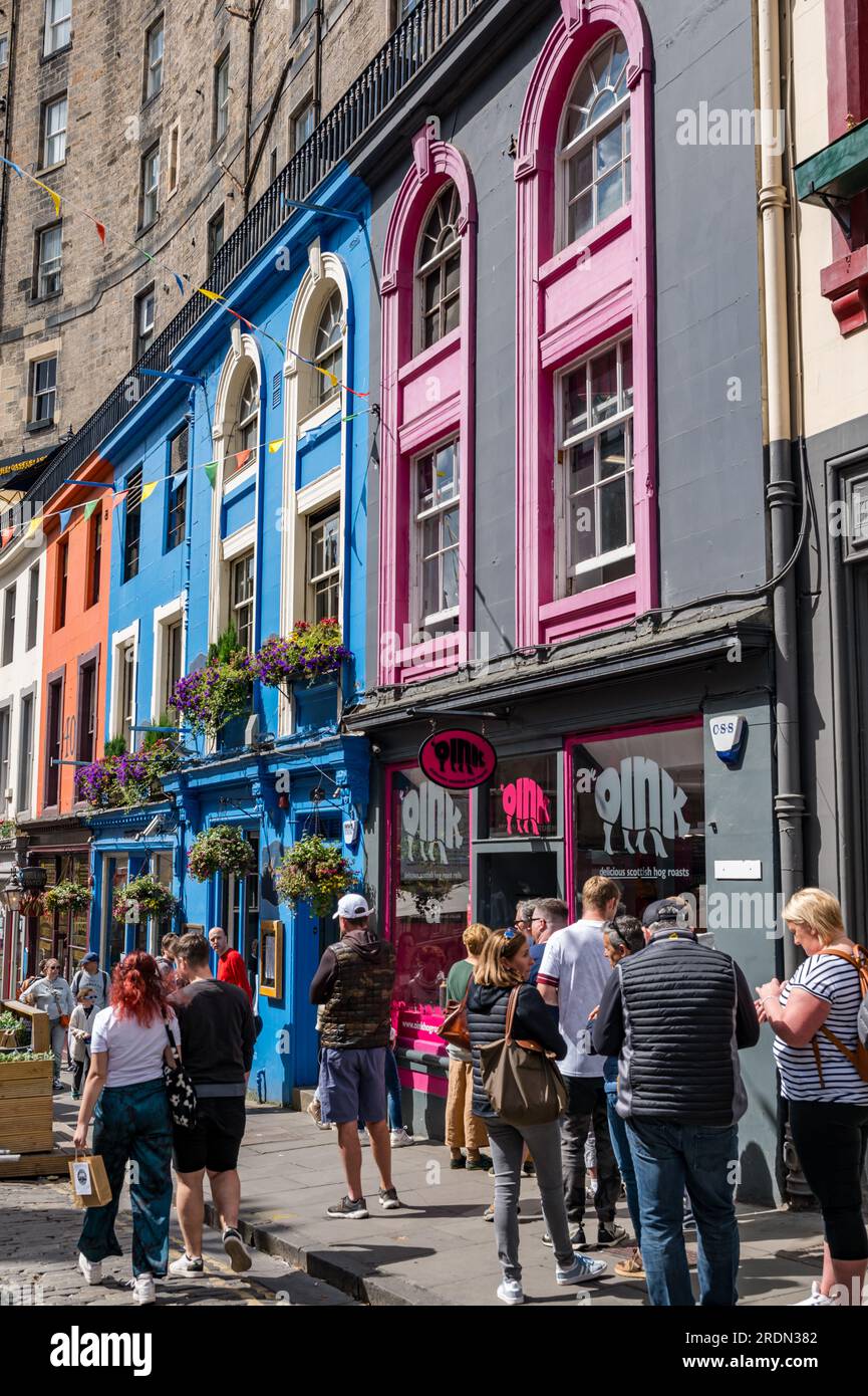 Crowd of people in Victoria Street with colourful painted shop fronts, Edinburgh, Scotland, UK Stock Photo