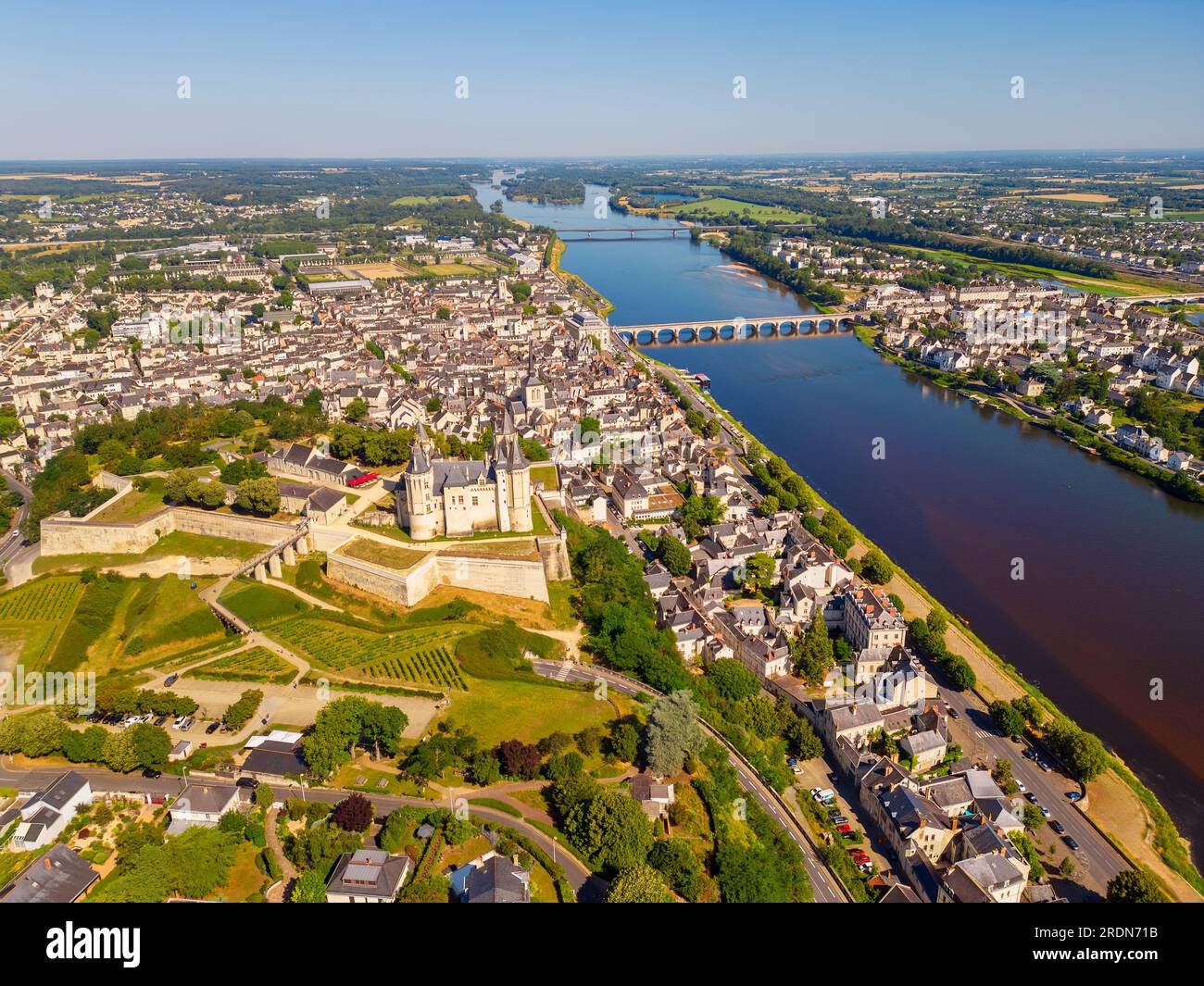 High angle Drone Point of View on the City of Saumur, Pays de la Loire, Northwestern France on summer day. The Loire River flows through Saumur. Stock Photo