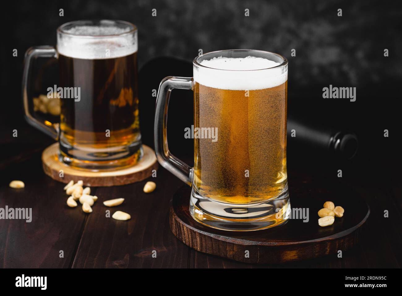 Mugs of lager beer and salty nuts. oktoberfest atmosphere, craft brewery background Stock Photo