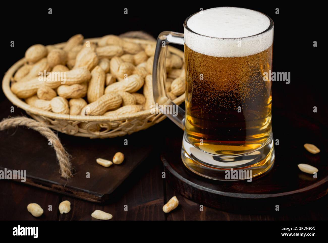 Mug of beer with foam and peanuts Pub background Stock Photo
