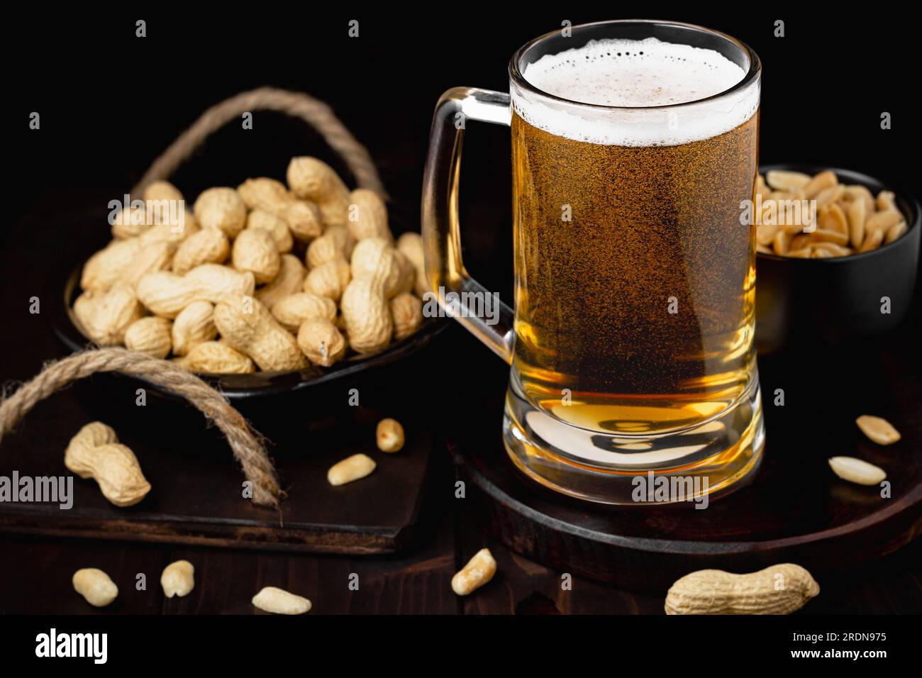 Mug of beer with foam and peanuts Pub background Stock Photo