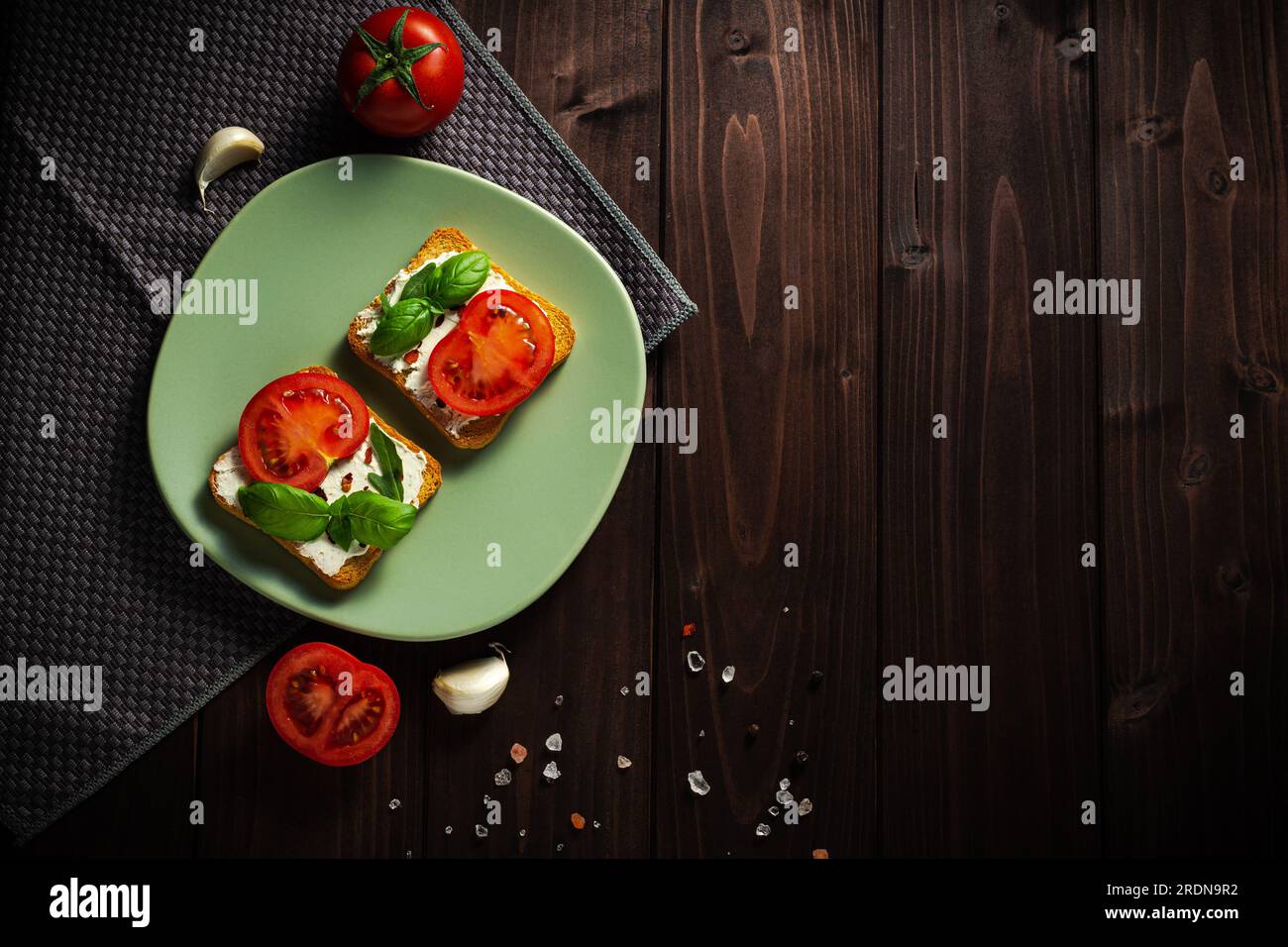 Variation of healthy toasts with avocado cream cheese and whole wheat rye bread on a plate