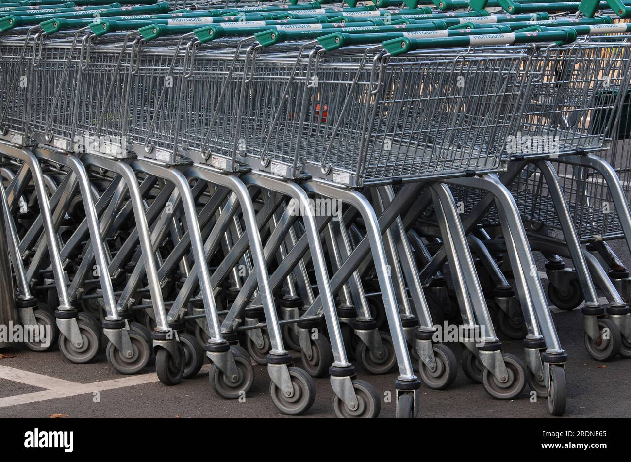 Morrisons supermarket shopping trolleys parked in trolley bay Stock