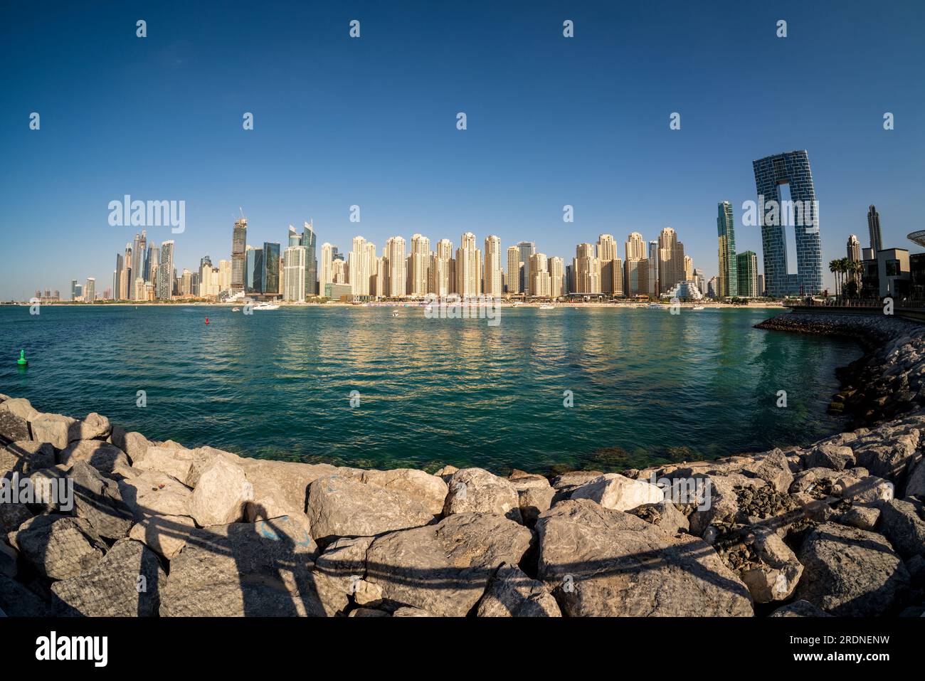 Wide panorama with fisheye lens of new apartments among hotels on oceanfront in Jumeirah Beach Residence area of Dubai Stock Photo