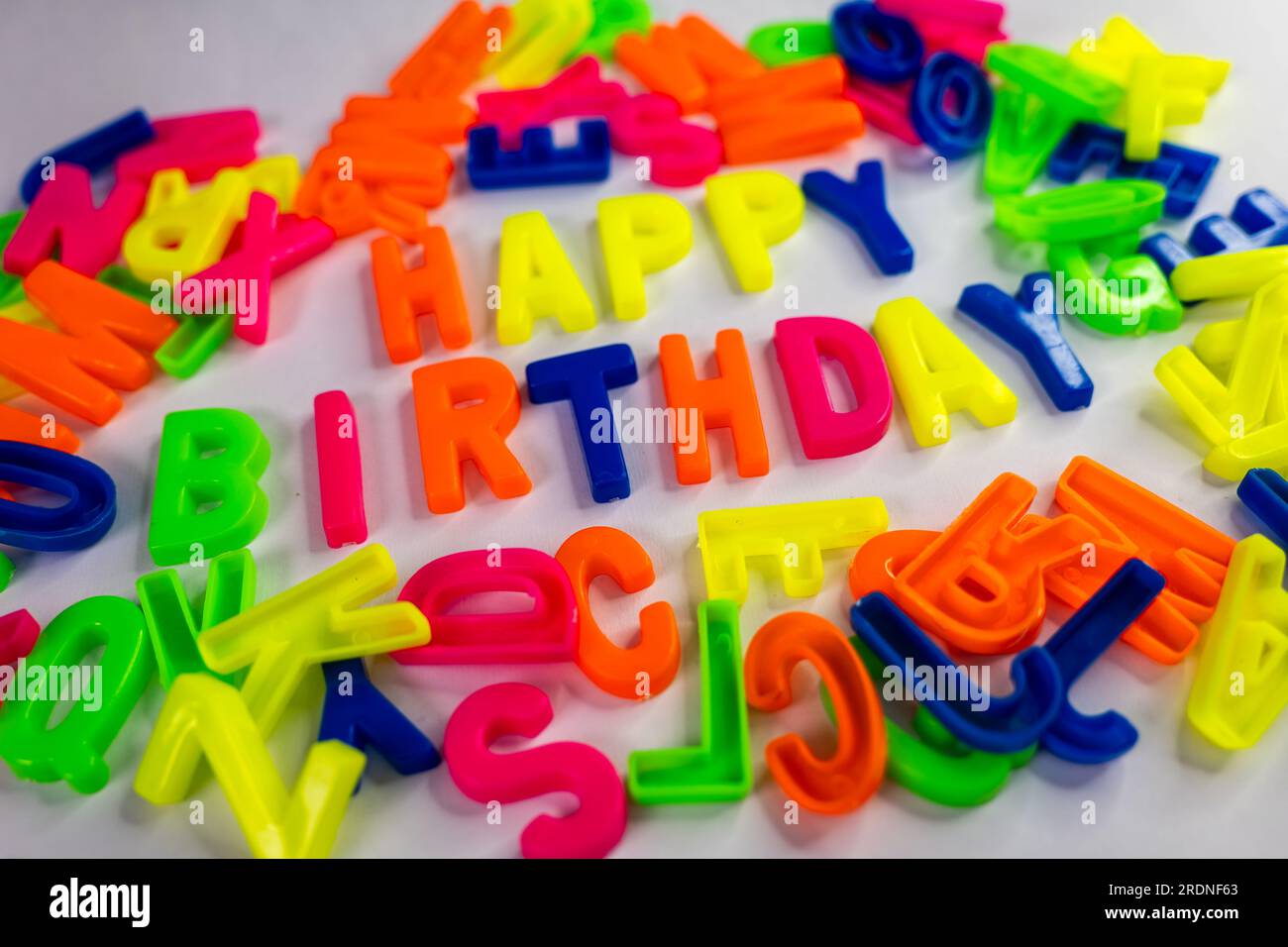 A closeup of the words "Happy Birthday" made from colorful letter