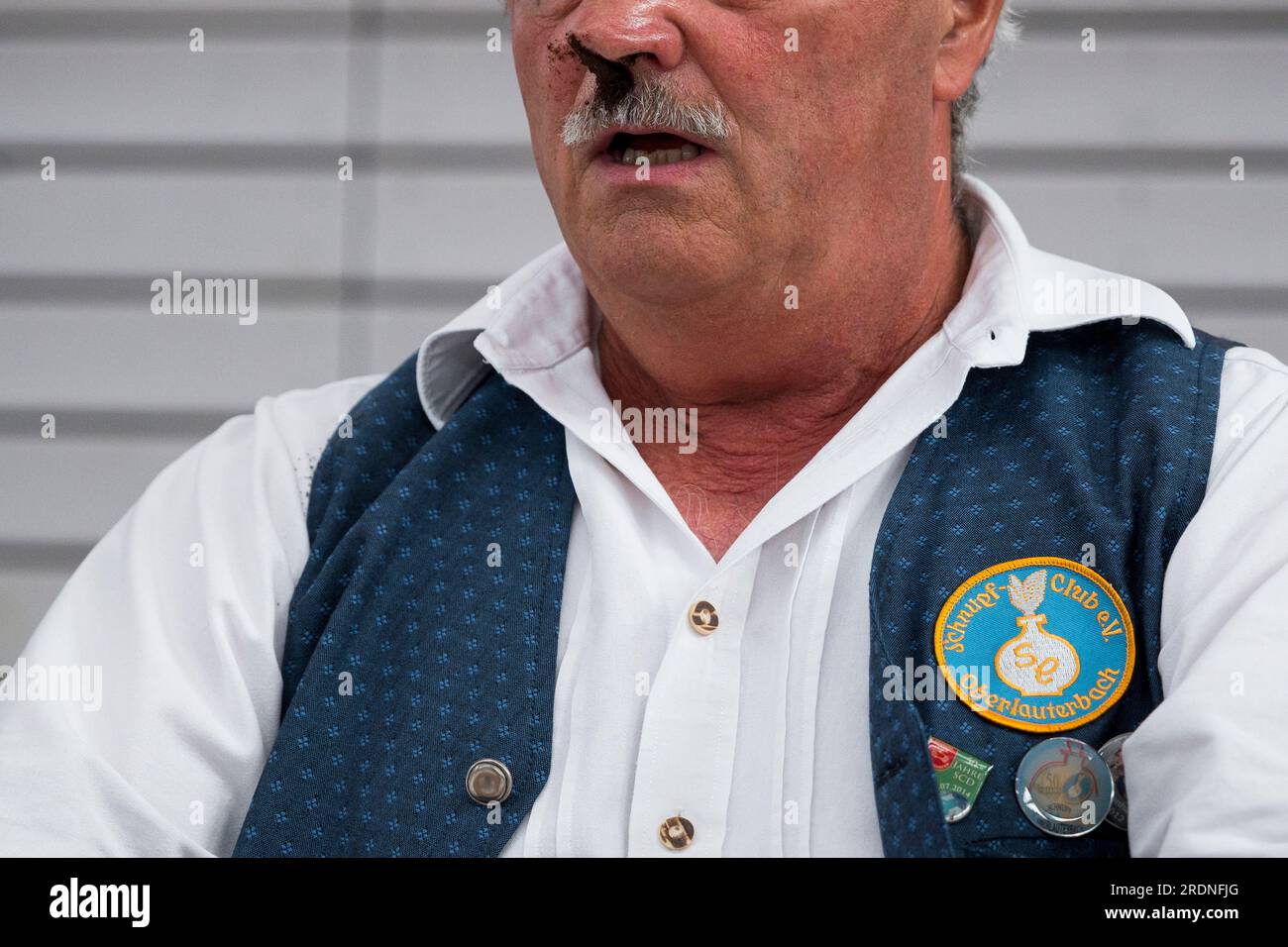 Markt Erlbach, Germany. 22nd July, 2023. A participant after snuffing the  5g of snuff. He holds still to keep as much tobacco as possible in his nose.  Within one minute the participants
